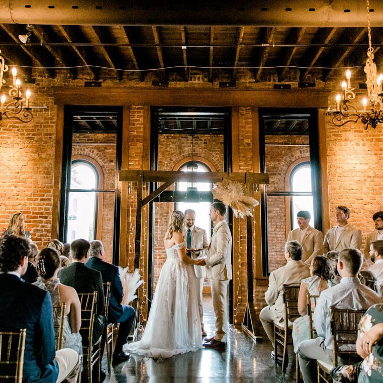 Wedding packages in chattanooga showcasing a bride and groom standing on stage preparing to be married.