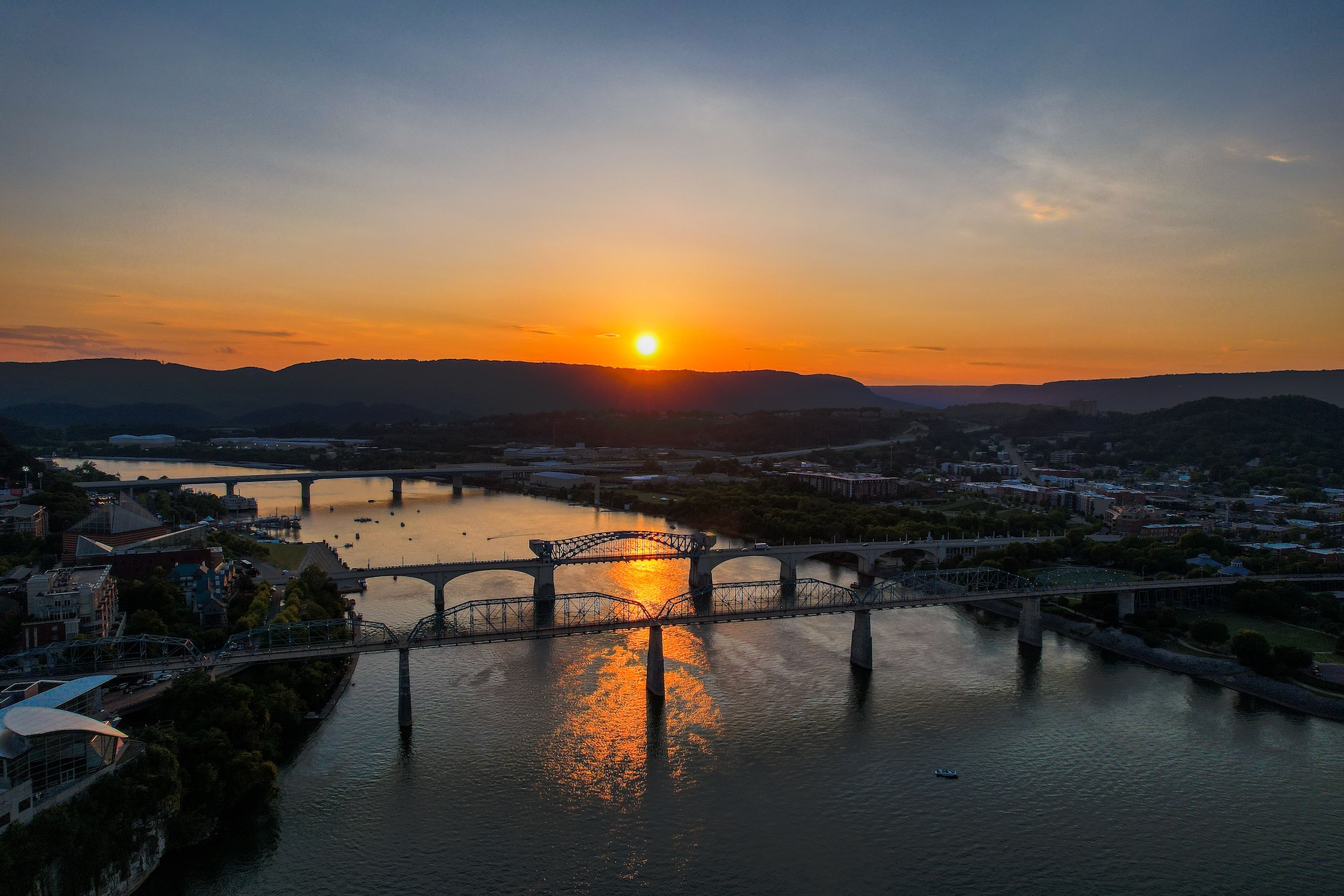 Stunning aerial view over Chattanooga with bridges at sunset, Tennessee river, USA Wedding packages in chattanooga showcasing a newly married couple walking down the isle.