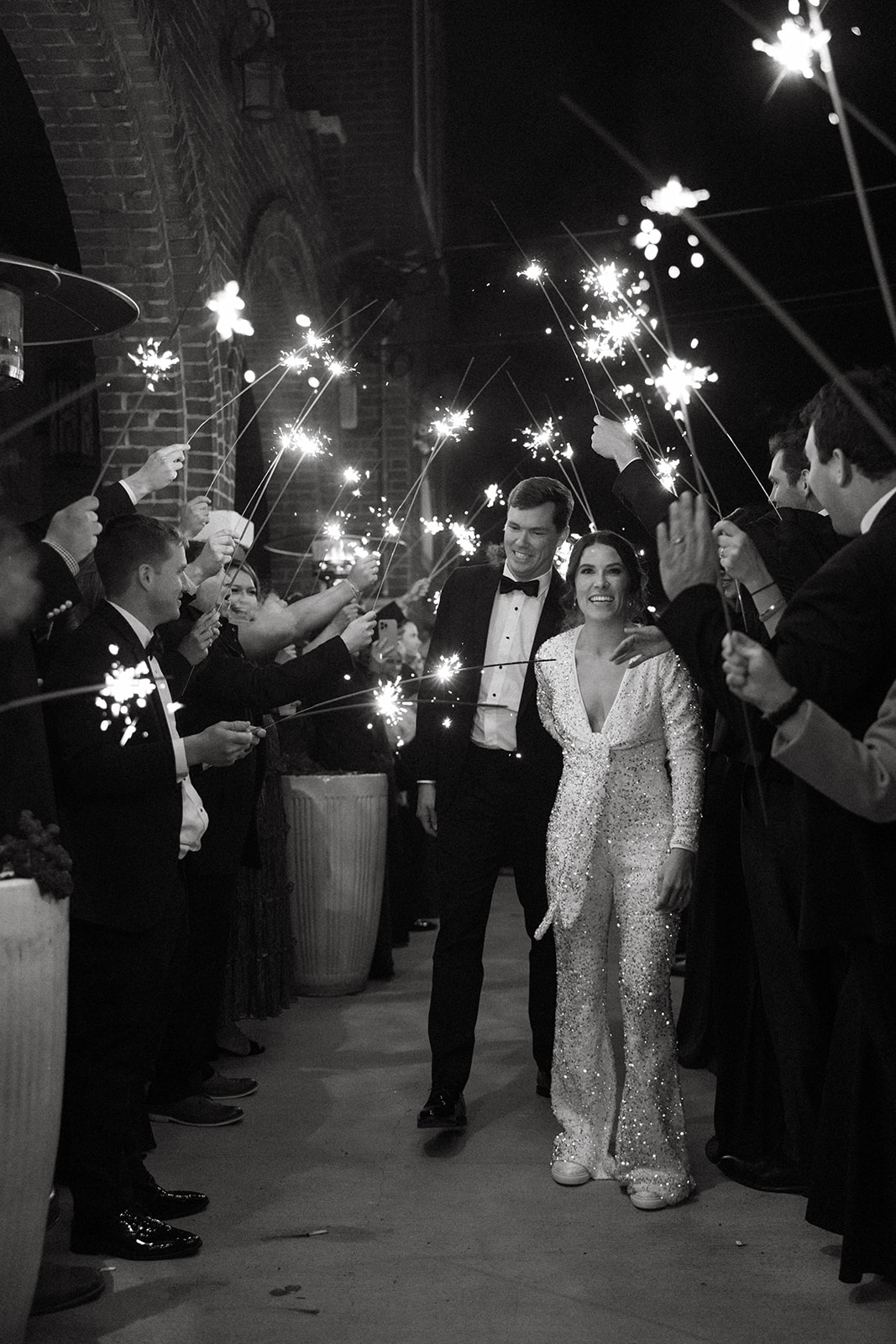Wedding planning resources showcasing colorful flowers sitting in a dark navy chair with a brick wall background.