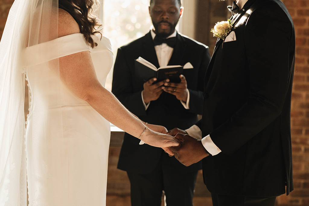 Wedding venue in Chattanooga showcasing married couple outside of a red, brick church.